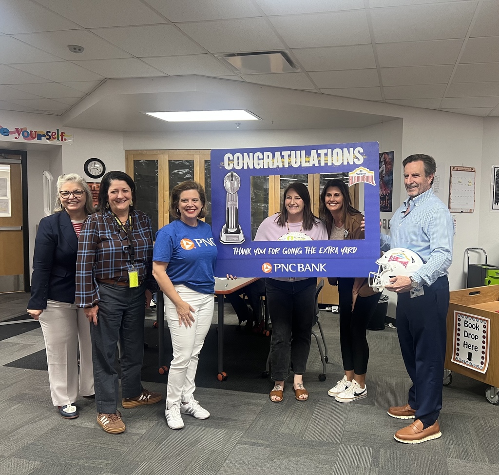 Group of teachers and guests smile after naming teacher as a grant recipient