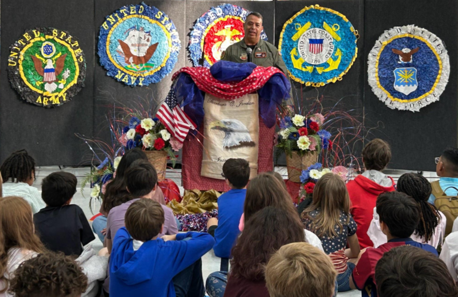 picture of a parent guest speaker at the veterans day assembly