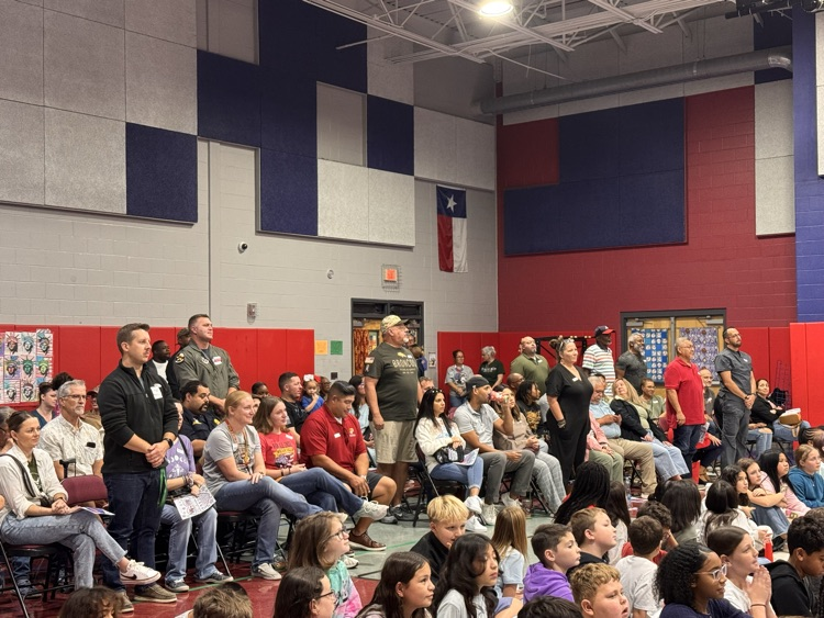 Veterans standing up in the crowd