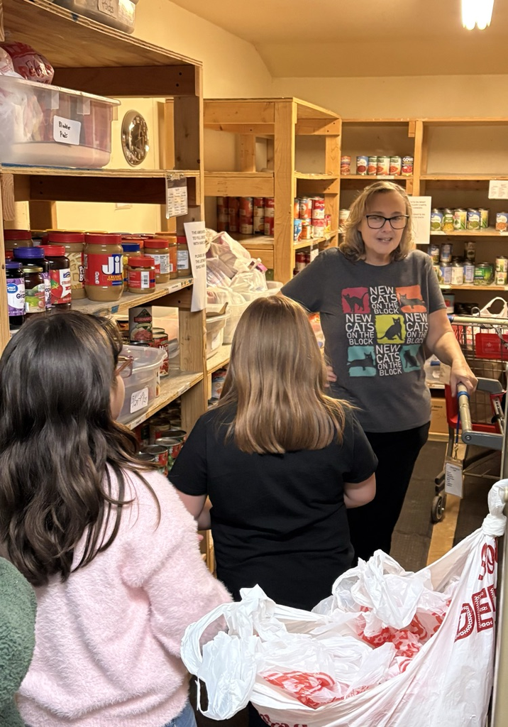 students making donation to RACAP