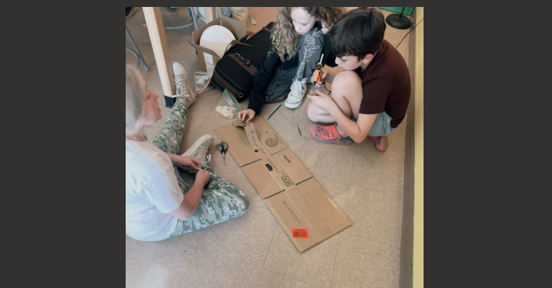 students building a cardboard rollercoaster