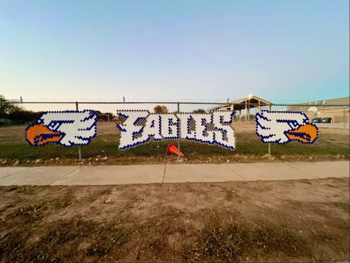picture of mascot and the word Eagles on fenceline