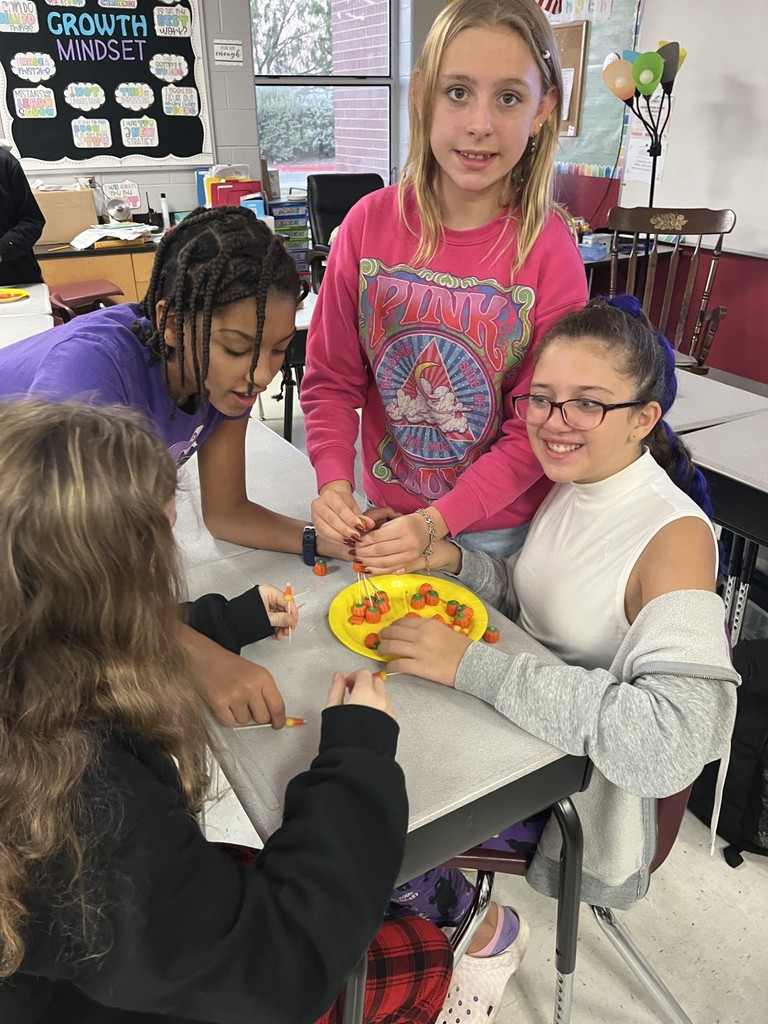 4 girls using the materials to build a tower