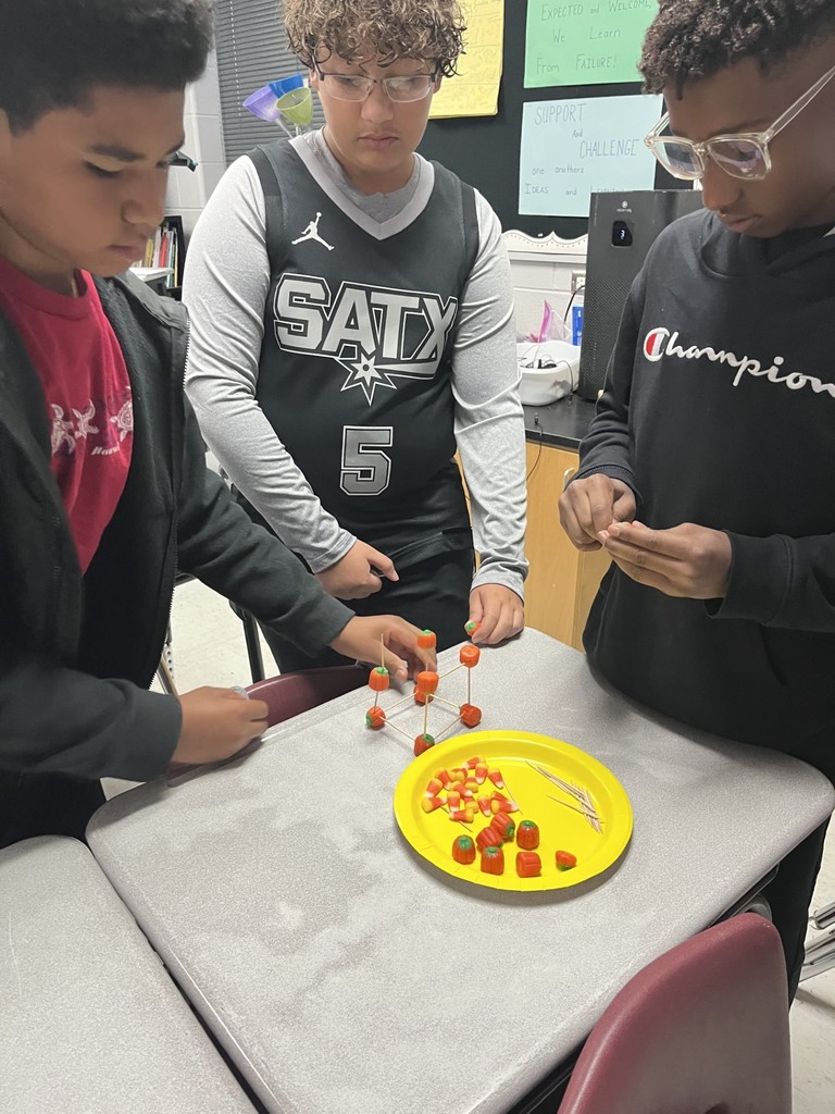 3  boiys using the materials to build a tower