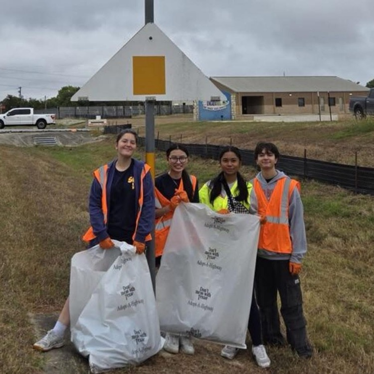 students clear trash from the roadside