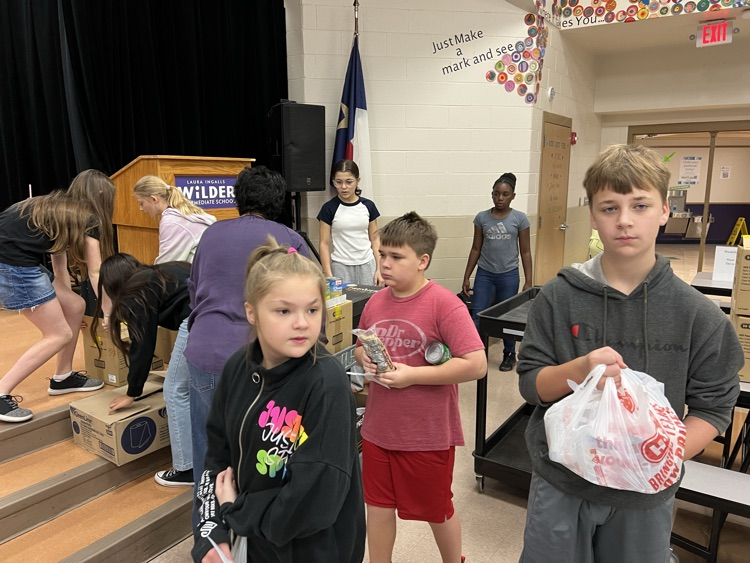 students loading up boxes of food