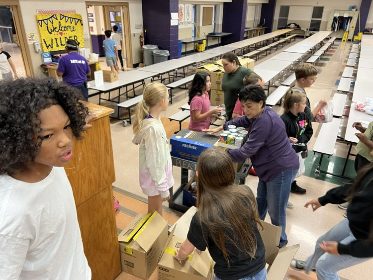 students closing boxes of canned goods