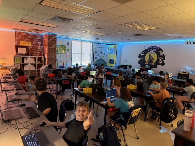 Minecraft Club members pose with their laptops