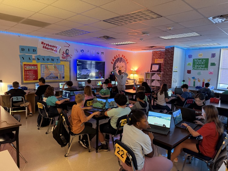 Minecraft Club members pose with their laptops