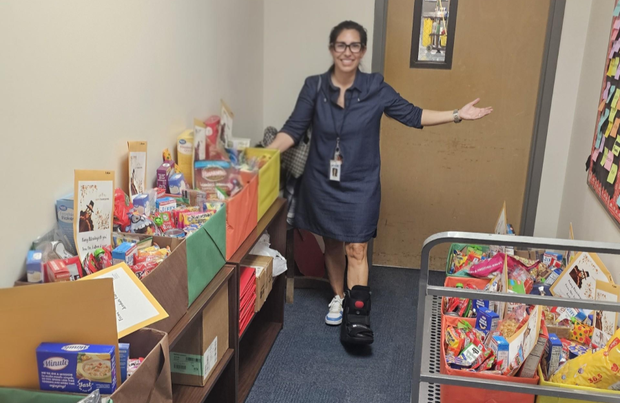 picture of Ms. Labron posing with food drive donations