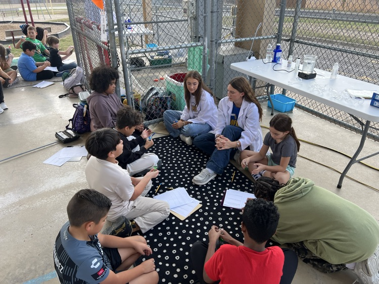 kids sitting outside learning about science