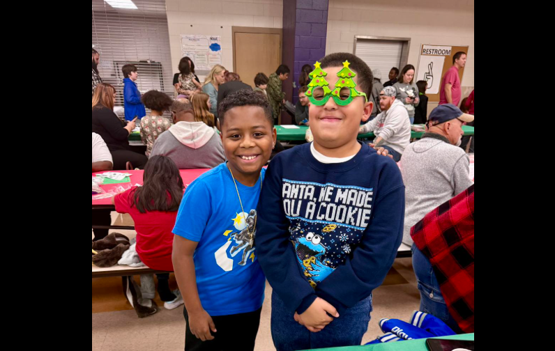 two boys posing for picture