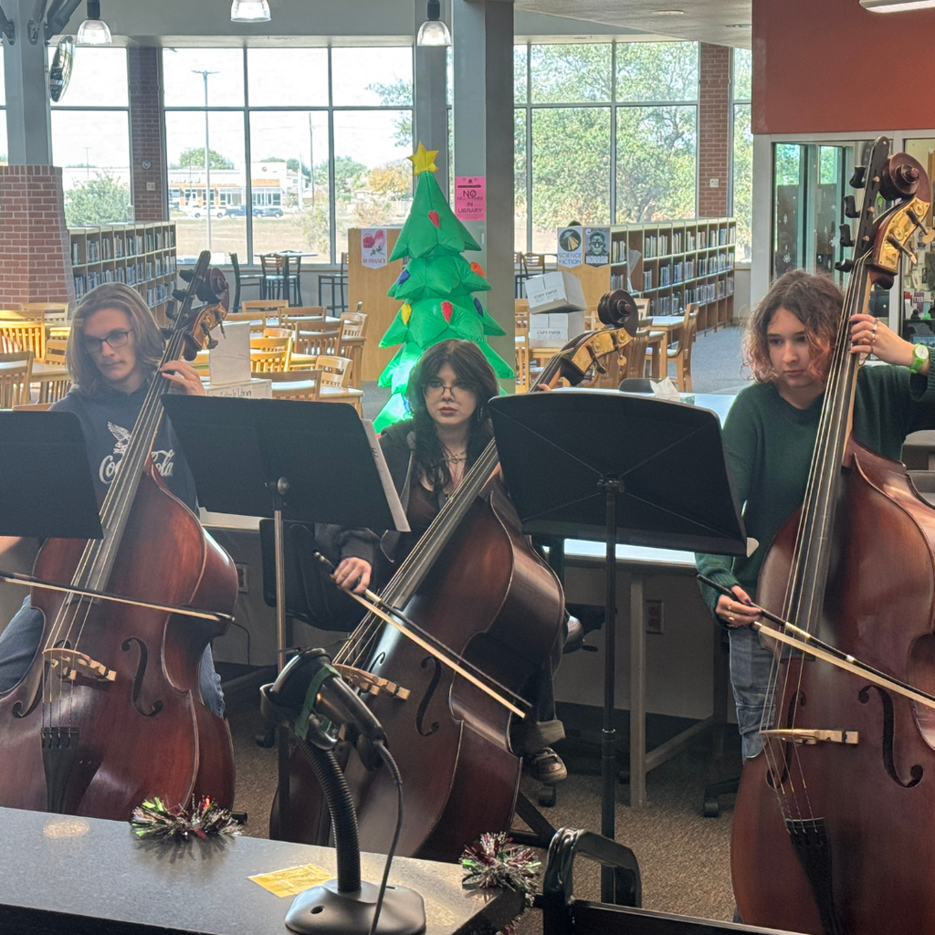 Students playing Chello's in the library