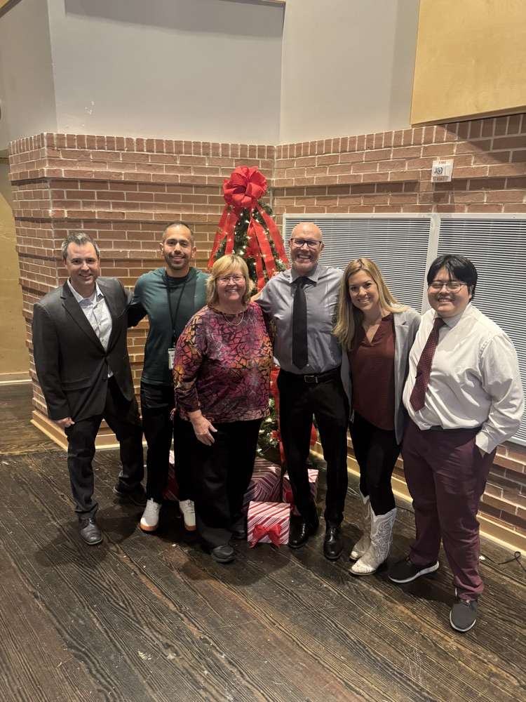all five directors posing with fine arts Director Beth Brock on the stage