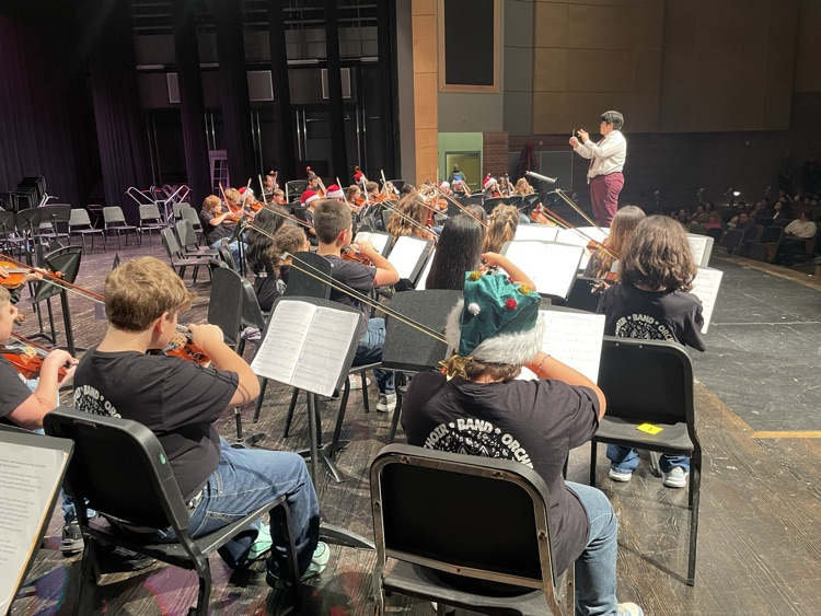Mr. Gonzales conducting the orchestra on the stage