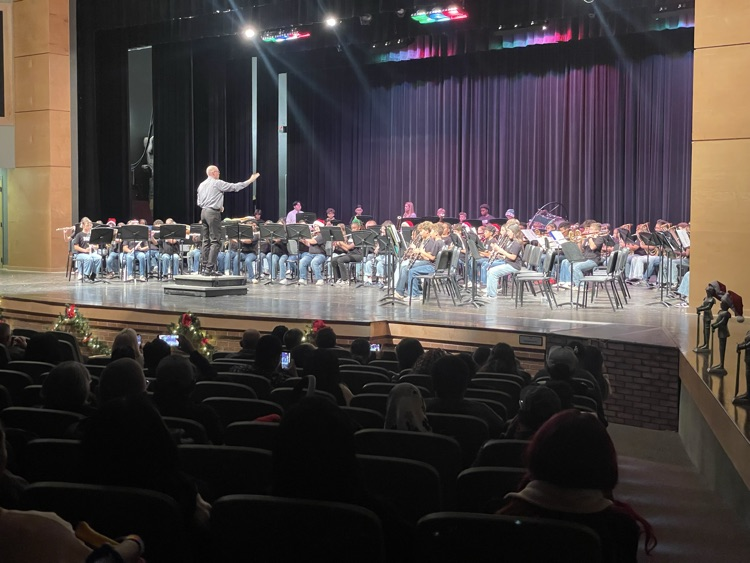 Mr. Post conducting the band on the stage