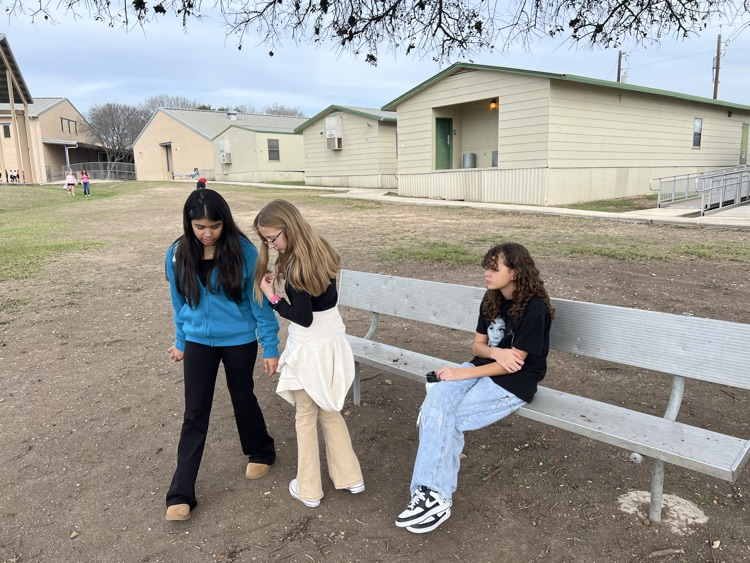 Girls talking at recess at bench