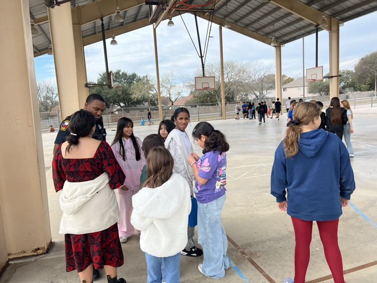 students talking with our SRO at recess