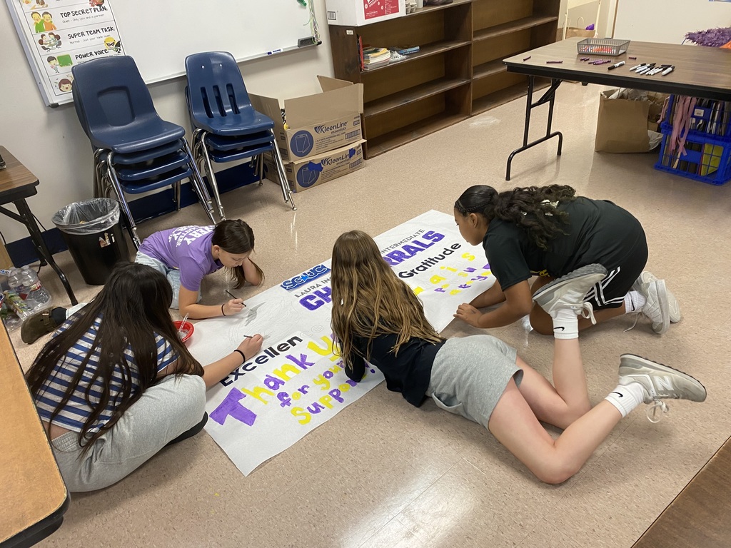 students on floor painting poster
