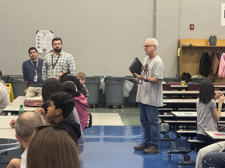 sixth grade teachers in the cafeteria explaining next year to parents