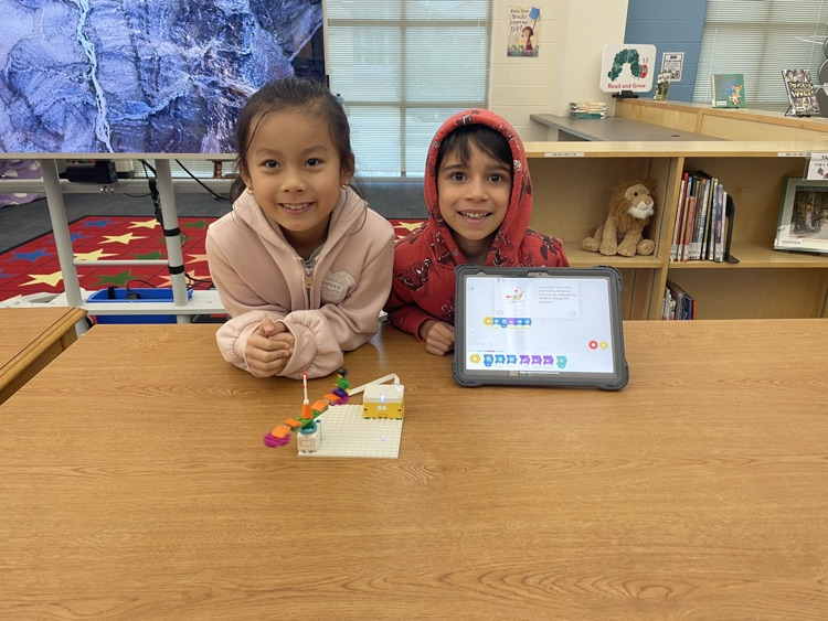 students building and coding Lego in the library