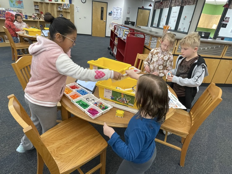 students building and coding Lego in the library