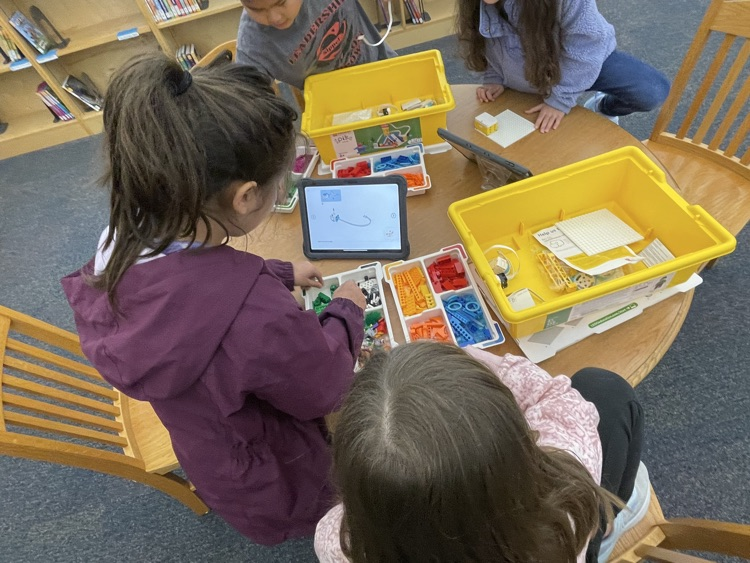 students building and coding Lego in the library