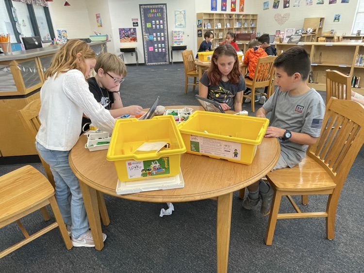 students building and coding Lego in the library