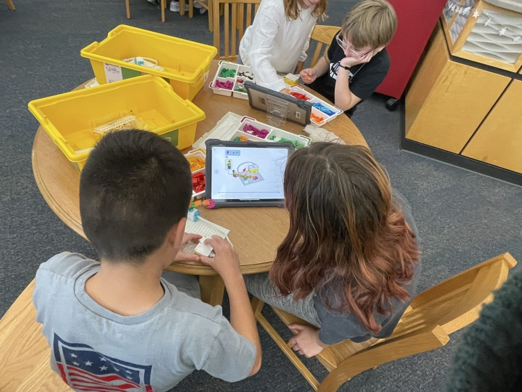 students building and coding Lego in the library