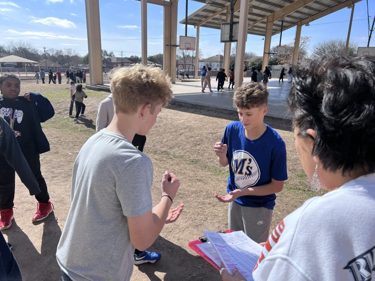 students about to shoot either rock, paper or scissors 