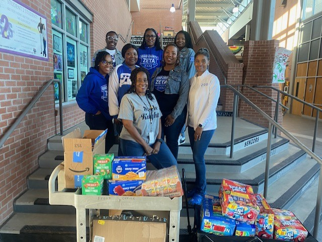 Aeta Phi Beta Sorority and Mrs. McGill with donations. 