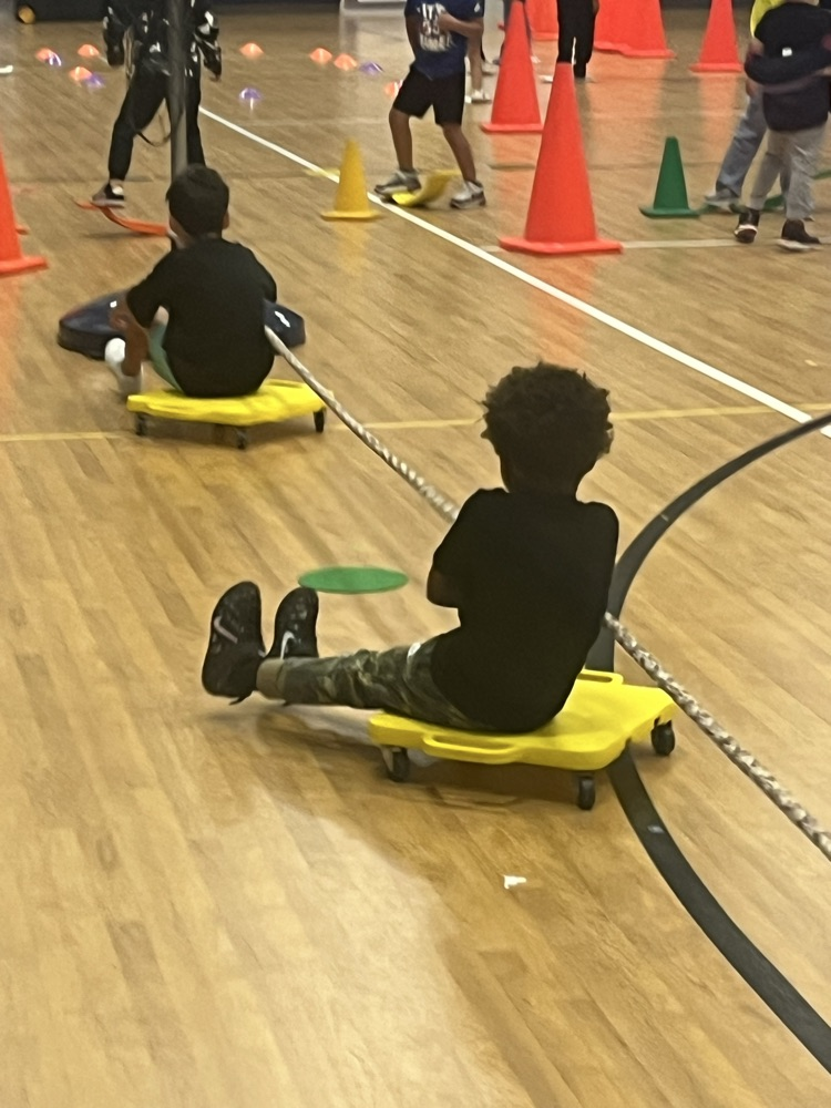 kids pulling on rope while on a scooter