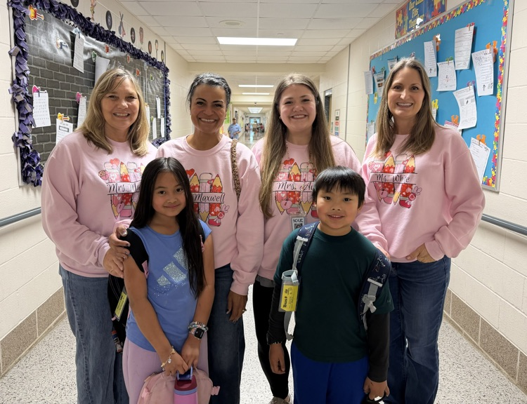 students with teachers after gifting them sweater shirts as a gift