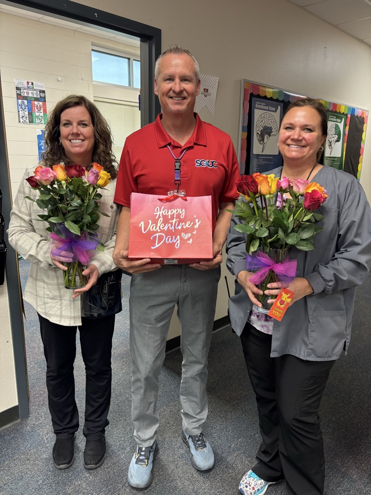 adults with flowers and treat bag