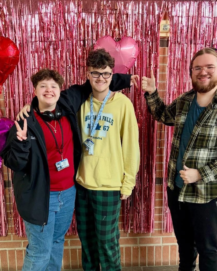students in front of a valentines background 