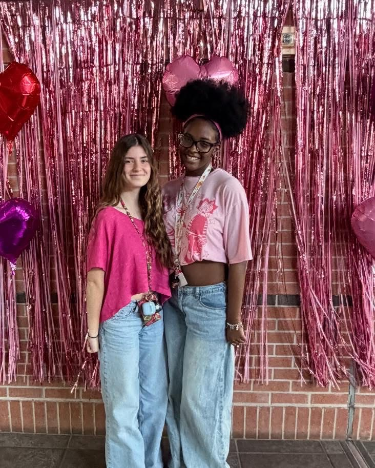 students in front of a valentines background 