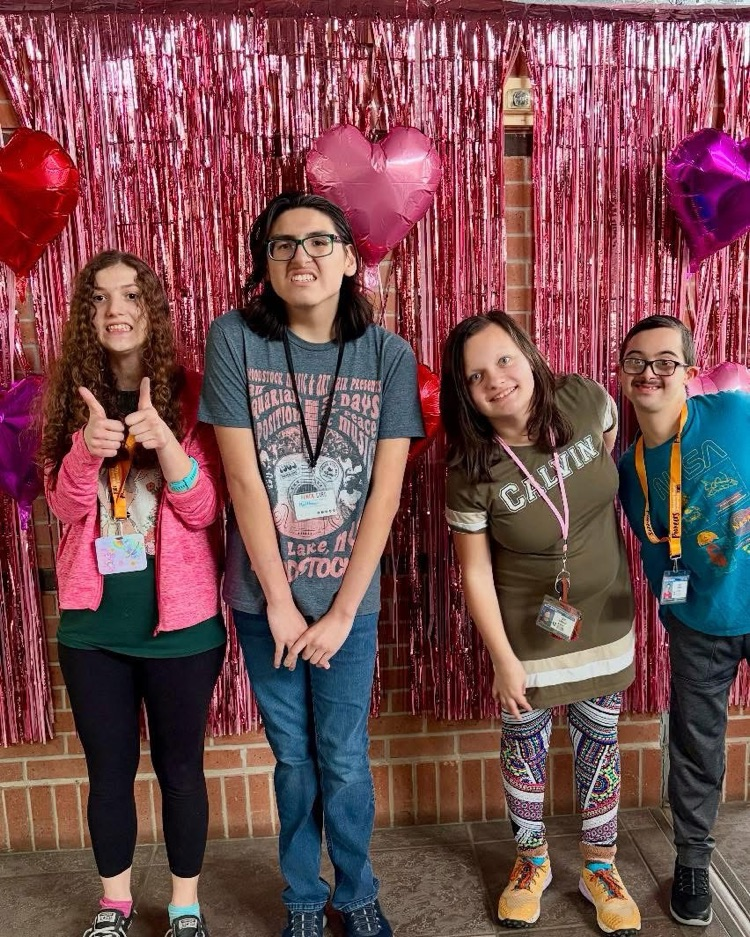students in front of a valentines background 