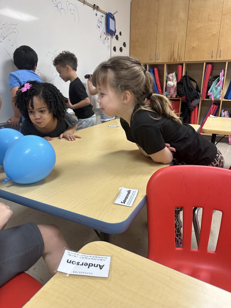 students learning about push and pull with balloons