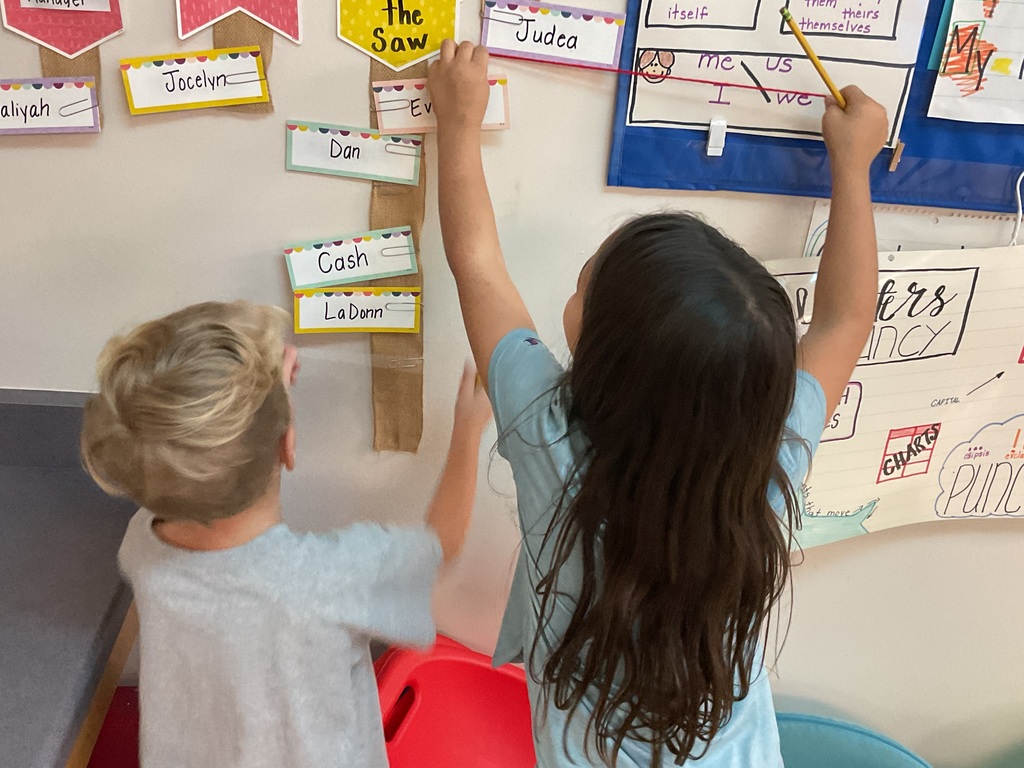 First graders measuring classroom objects. 