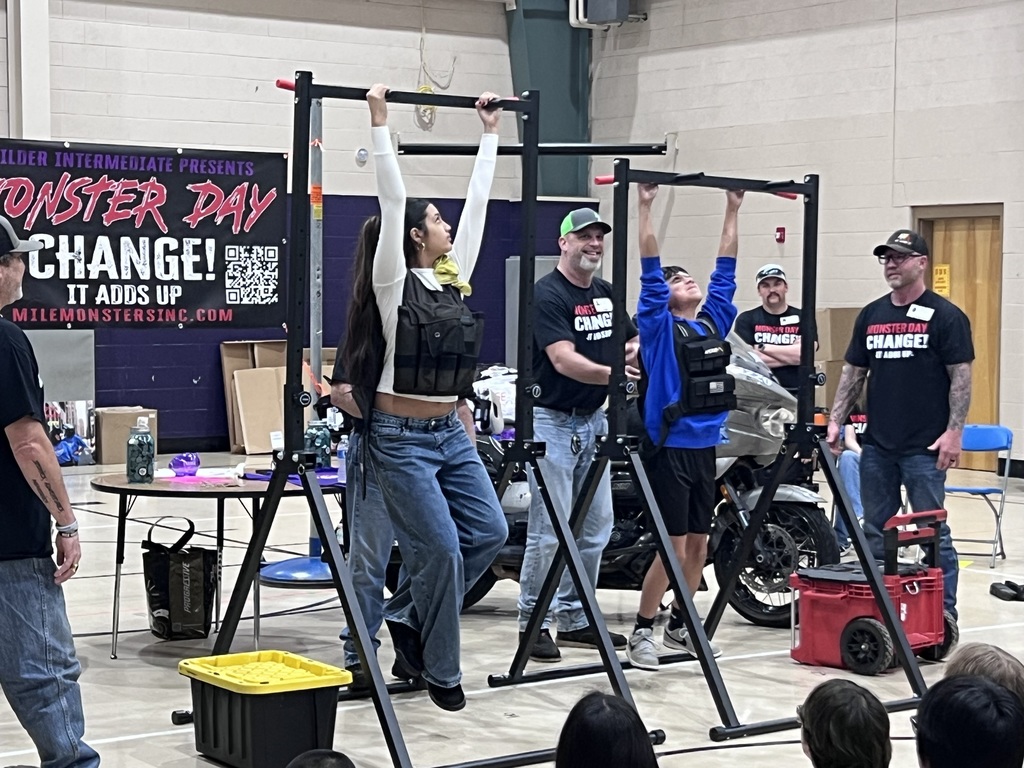 6th graders holding on to a bar as long as they can with a weighted vest