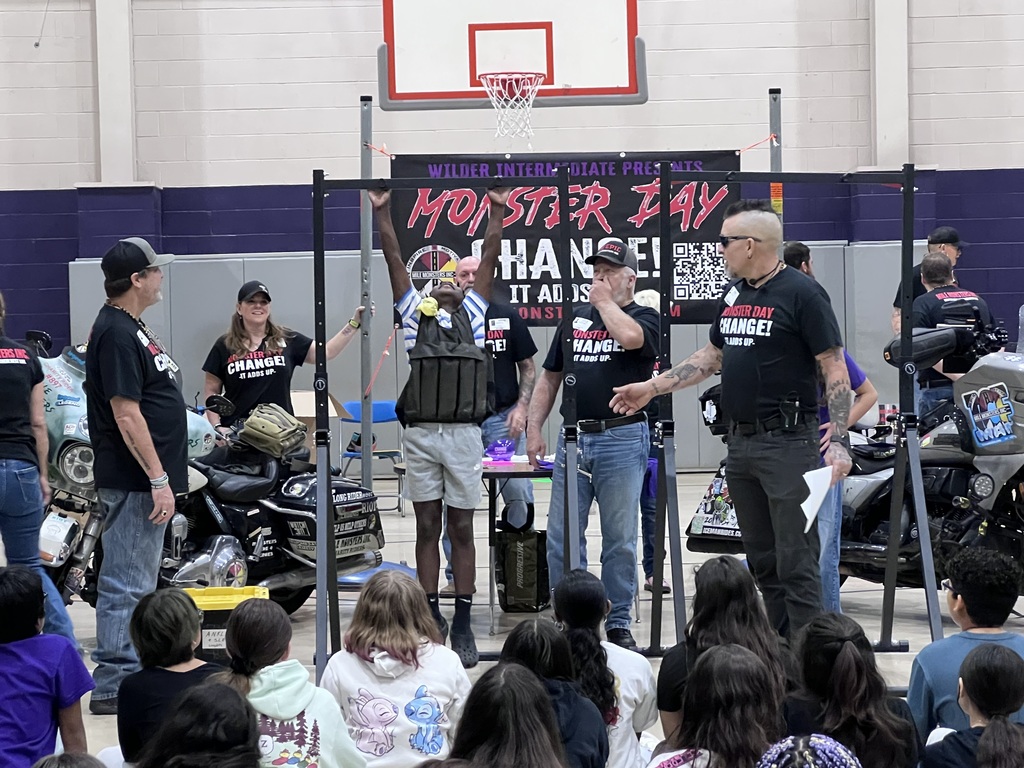 students testing their strenth with a weighted vest.