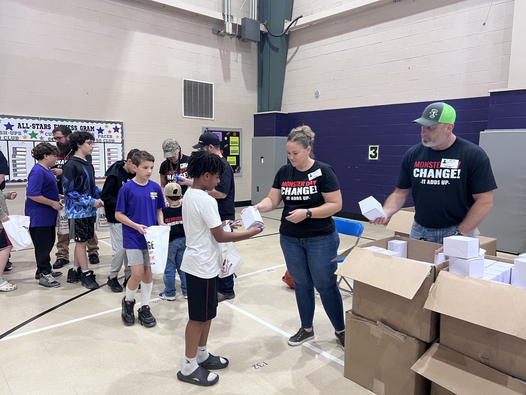 Students getting a goodie bag from the Mile Monsters.