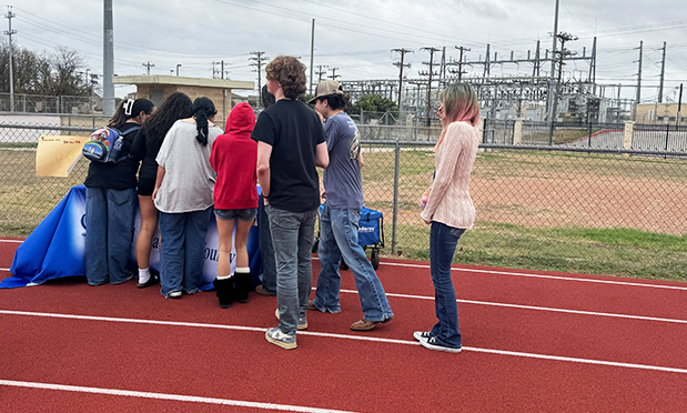 high school students gather around a table promoting mental health for teens