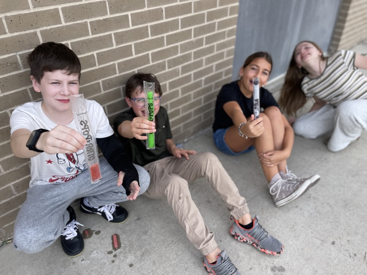 kids sitting having a popsicle outside
