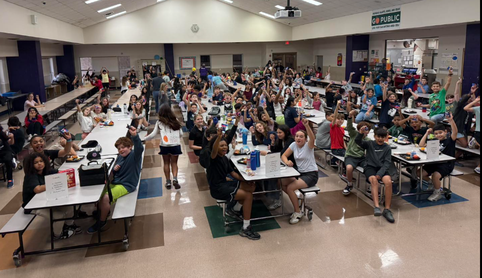 students in cafe holding up oreos