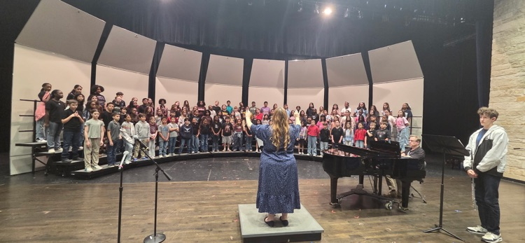 husky choir practicing with director