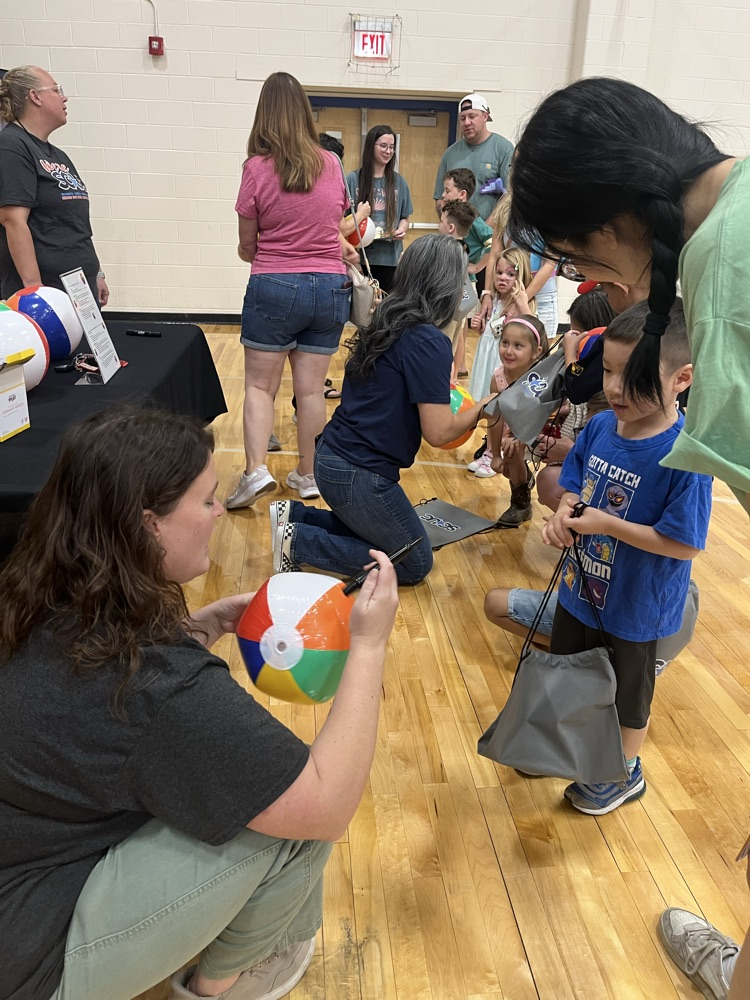 adult riding on a beach ball for a three year-old