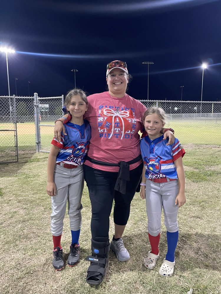 students and teacher at softball game