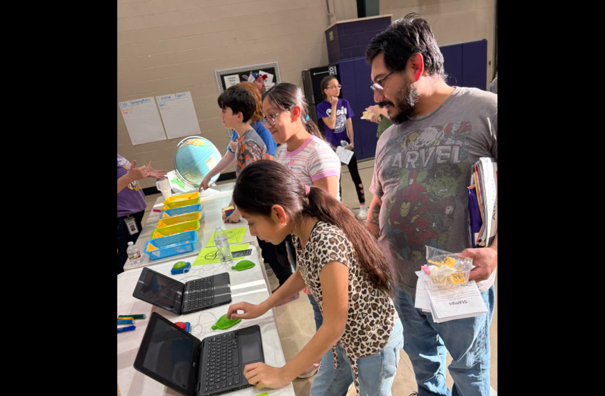 families in gym on computers