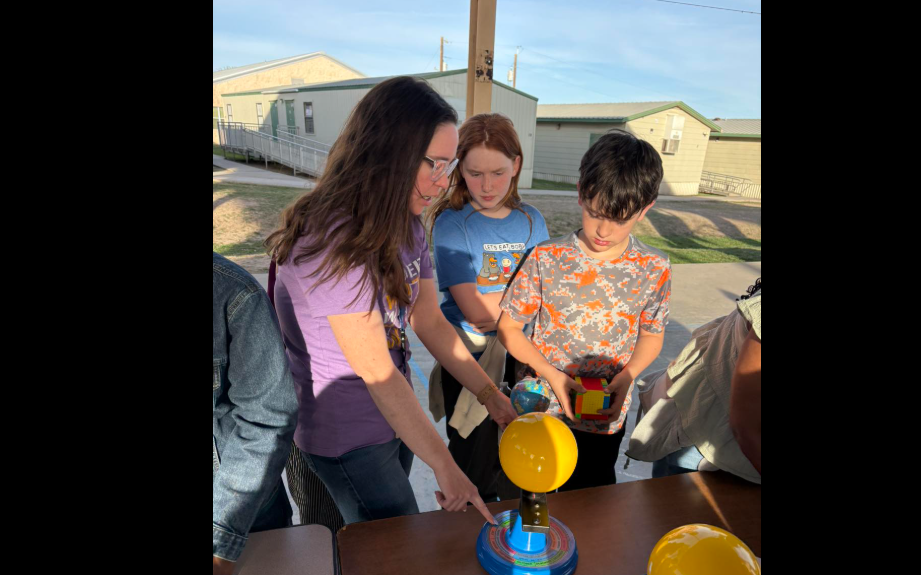 Ms. Reagan helping studen with activity